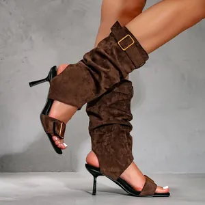 Stylish brown suede stiletto sandal boots with buckles for a chic summer look.