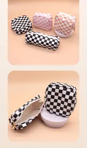 Close-up of checkerboard pattern PU cosmetic bags showing zipper detail and interior