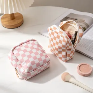 Portable checkered PU makeup bag for travel with zipper closure and compact design