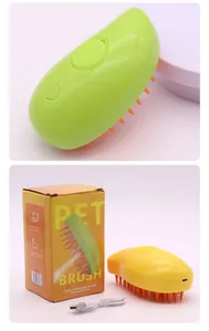 Macro view of mango-shaped electric pet spray massage brush and its retail packaging