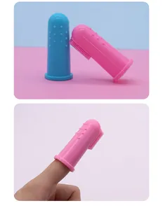 Detalle de primer plano de un cepillo de dientes de silicona rosa para mascotas en dedo