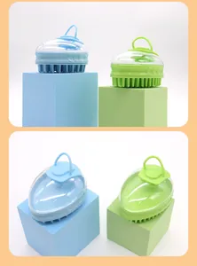 Side and top views of blue and green silicone pet massage brushes on color-matched blocks