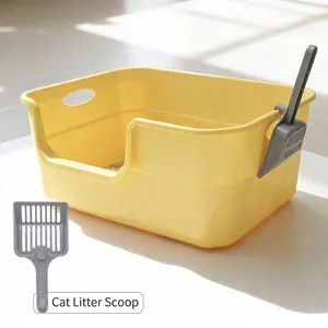 Große offene gelbe Katzentoilette mit Spritzschutz und grauer Schaufel dabei