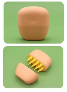 Detail view of pet bath massage brush with soft yellow silicone bristles in orange case