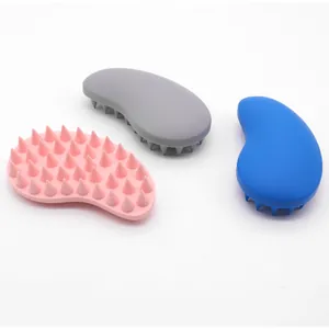 Macro view showing high-quality silicone pet bath massage brushes in pink grey and blue colors