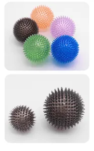 Detailed view of colorful TPR spiky pet balls showing size comparison for active dogs