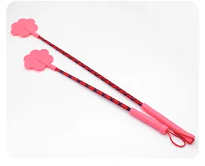 Close-up detail of two pink paw-shaped dog training sticks featuring red braided nylon handles