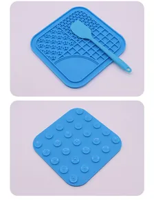 Blue silicone pet lick mat set featuring suction cups and a matching spatula tool