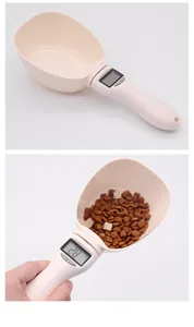 Detailed view of electronic pet food measuring spoon showing weight on LCD screen
