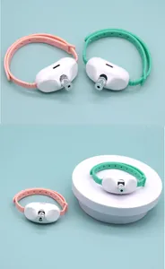 Detail shot of rechargeable wearable laser cat collars in pink and green silicone.