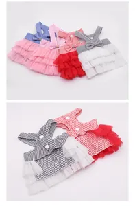 Detailed view of colorful pet princess dresses with striped tops and tiered mesh skirts.