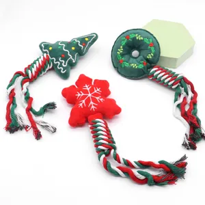 Set of three Christmas themed plush dog toys with colorful braided cotton rope tails