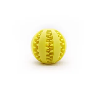 Durable yellow rubber dog chew ball with textured surface for molar teeth cleaning