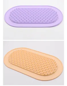 Two silicone pet licking mats in purple and orange with a textured slow feeder surface