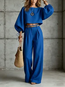 Full body view of women's royal blue bubble sleeve crop top and matching high waist wide-leg trousers