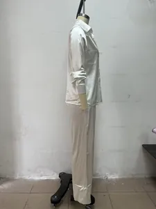 Side view of women's minimalist white long-sleeved shirt and trousers two-piece suit set