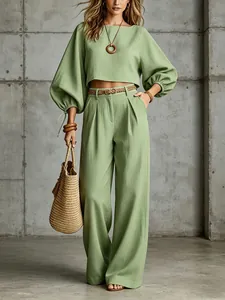 Elegant sage green outfit featuring balloon sleeves and flowing wide-leg trousers style