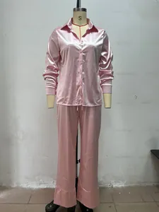 Detailed view of pink satin long-sleeved pajama set for women in minimalist style
