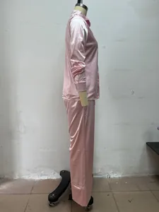 Side view of pink long-sleeved satin pajama set for women on mannequin stand detail