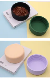 Multi-colored thickened silicone pet bowls for food and water in a minimalist setting.