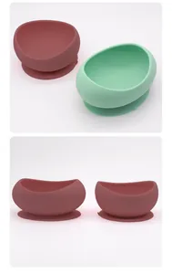 Macro detail of silicone pet bowl with strong suction base in red and green colors