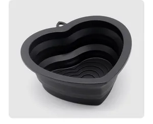 Close-up view of the layered structure of a black heart-shaped collapsible silicone bowl