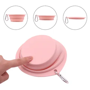 Portable pink collapsible silicone pet bowl with a silver carabiner for dogs and cats.
