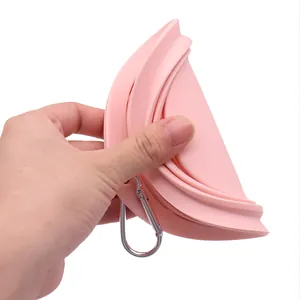 Portable pink collapsible silicone pet bowl with a metal carabiner for dogs and cats