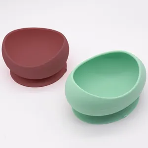 Two-piece silicone pet bowl set featuring non-slip suction bases in burgundy and mint green