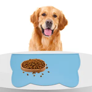 Blue cloud-shaped silicone non-slip pet feeding mat for dogs and cats on white table