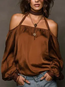 Detailed view of brown off-the-shoulder matte satin blouse with halter neck detail.