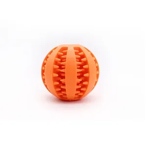 Durable orange rubber dog treat dispenser ball for teething and interactive playing