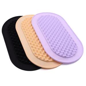 Durable oval silicone pet lick mats in purple, orange, and black for slow feeding