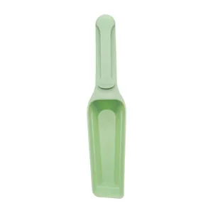 Pale green pet food scoop featuring an integrated bag sealing clip handle design