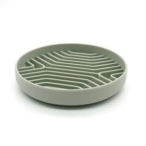 Round silicone slow feeder dog bowl with anti-slip maze design in soft sage green finish