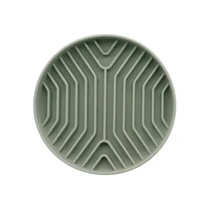 Round silicone slow feeder bowl for dogs with non-slip grooved design in green