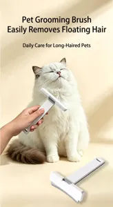 Professional pet de-shedding tool removing loose hair from a long-haired white cat