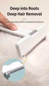 Detailed view of a white pet de-shedding tool with fine metal teeth for undercoat removal