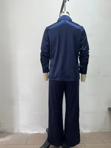 Back view of minimalist navy blue satin two-piece set featuring long sleeve shirt and pants.