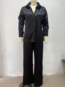 Full view of black long sleeve shirt and wide-leg pants set on mannequin