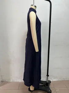 Side view of minimalist navy blue sleeveless maxi dress with stand collar on mannequin