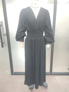 Elegant black pleated maxi dress featuring a V-neck and cinched waist on mannequin