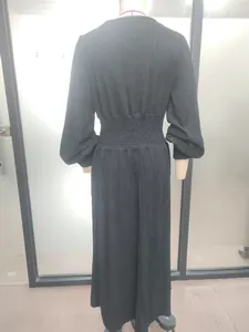 Detailed back view of a black smocked waist maxi dress with elegant long sleeves