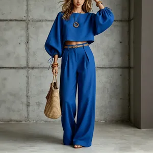 Elegant blue two-piece set featuring a puff sleeve crop top and wide-leg casual trousers