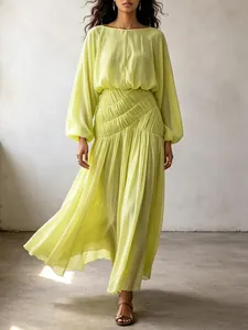 Detail of a bohemian lime green maxi dress with lantern sleeves and ruched waist