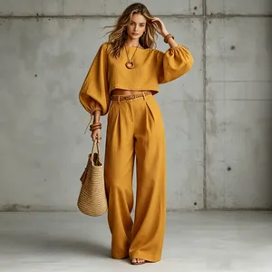 Two-piece mustard yellow set with lantern-sleeve cropped top and wide-leg trousers.