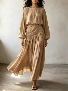 Elegant bohemian maxi dress featuring lantern sleeves and a smocked waist for a flowing look.