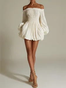 Full view of white off-the-shoulder pleated mini dress featuring smocked waist detail