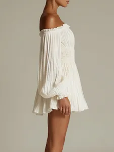 Side view detail of a white off-the-shoulder pleated mini dress with a smocked waist