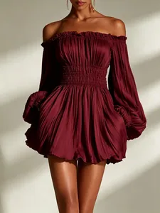 Detail of burgundy off-the-shoulder pleated mini dress with long sleeves and smocked waist.
